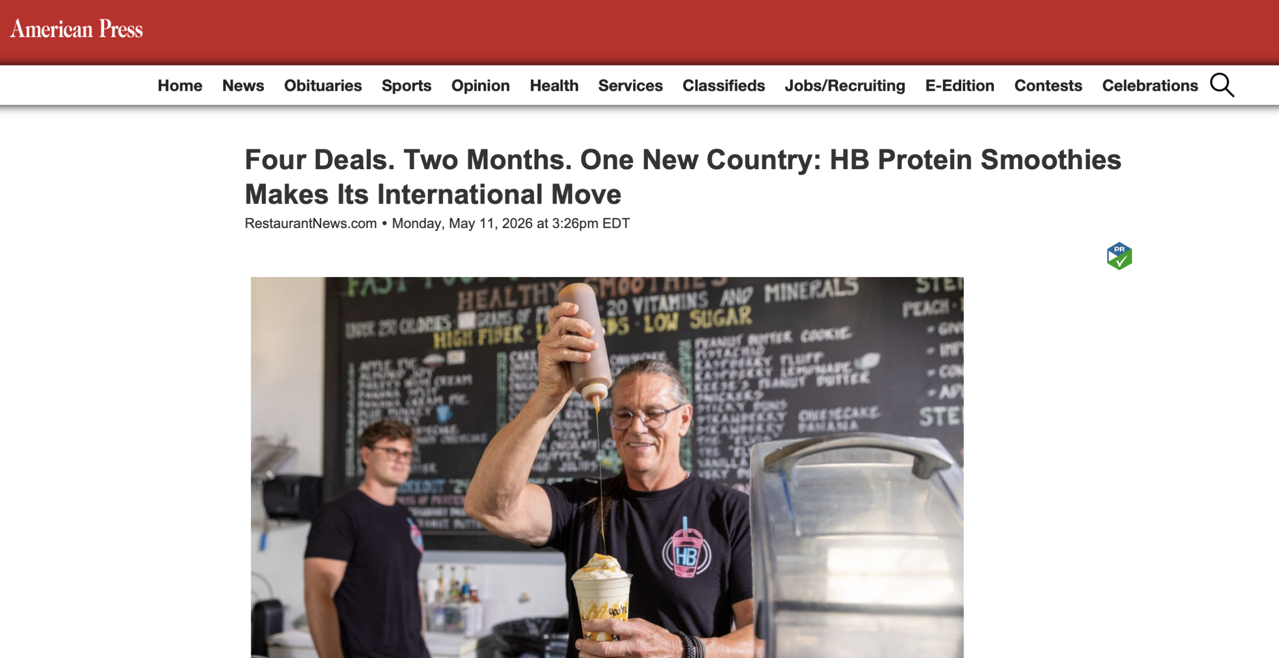 Man pouring caramel sauce from plastic bottle onto creamy protein smoothie in clear plastic cup